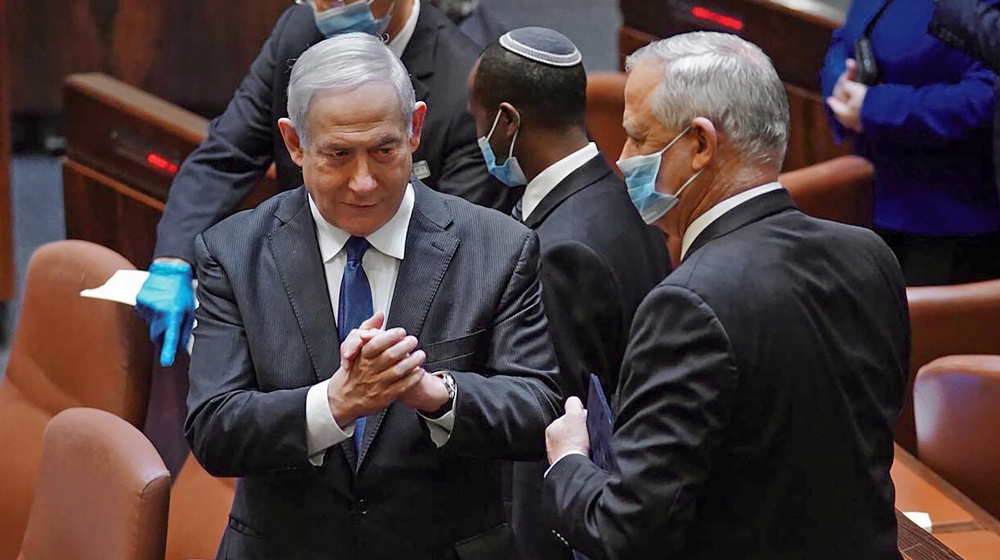 After more than 500 days without a stable government and three inconclusive elections, lawmakers approved a Netanyahu-Gantz coalition [Adina Valman/Knesset via AFP]
