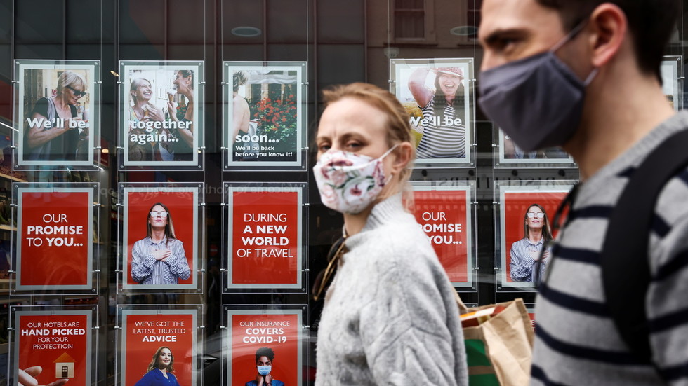 Masks and distancing could be required for several more YEARS, British public health expert says